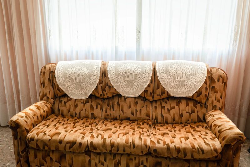 Crochet headrest sofa granny style in an eighties living room.