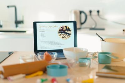 Person browsing a cooking blog about cheesy shortcakes on a laptop.