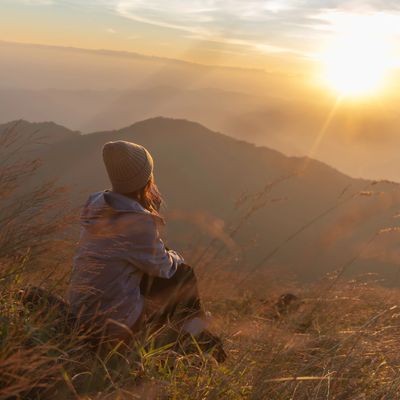 Person watching sunrise on a mountain.