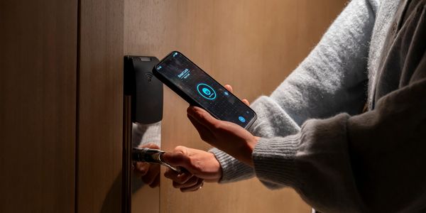 Person unlocking door with cell phone
