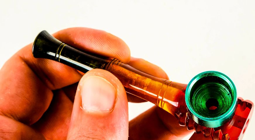 Set of glass smoking pipe stems and a clear glass bowl.