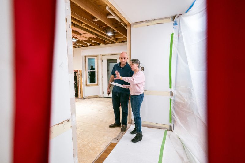 Mature couple supervising home renovation progress