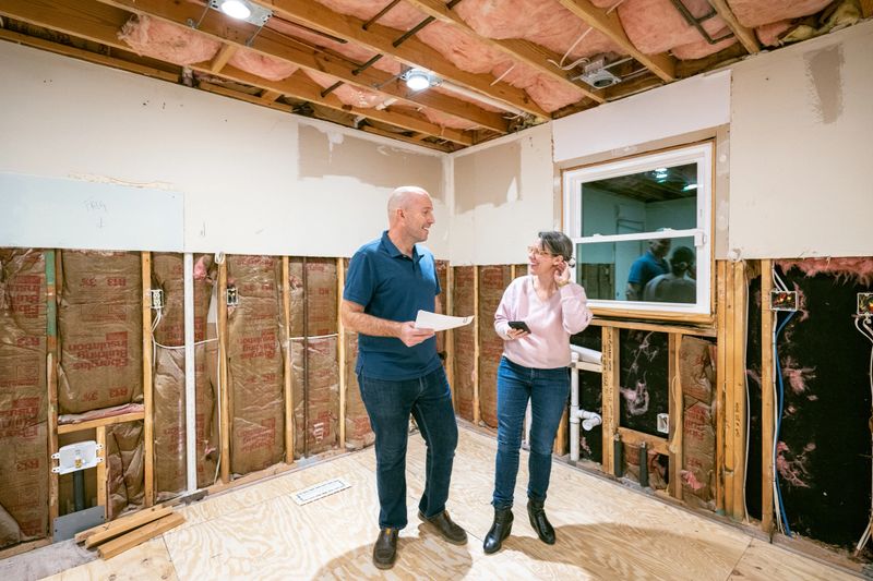 Mature couple supervising home renovation progress