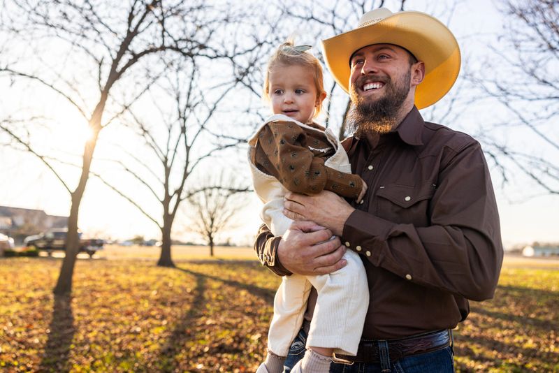 A Texas dad holding his daughter outdoors