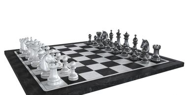 A chessboard with silver and black chess pieces set for a game.
