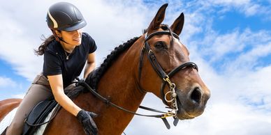 Horse rider patting horse neck 
