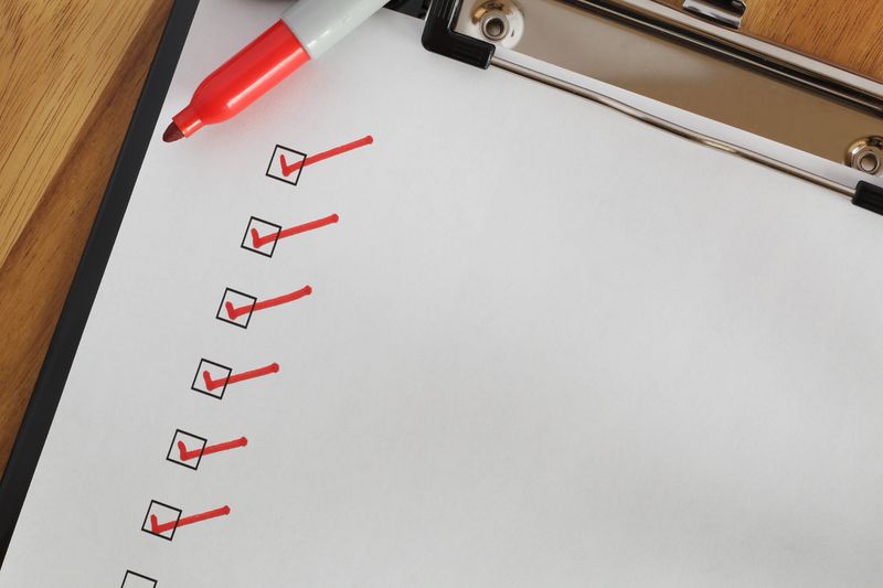 Checklist boxes close up with red ticks and marker