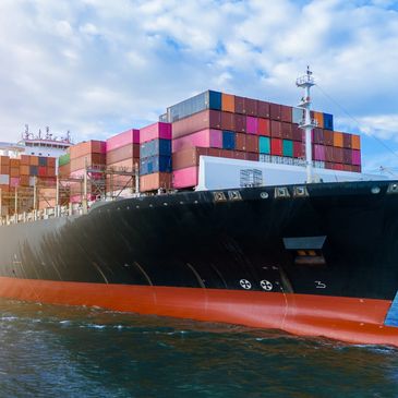 Large cargo ship loaded with colorful containers.