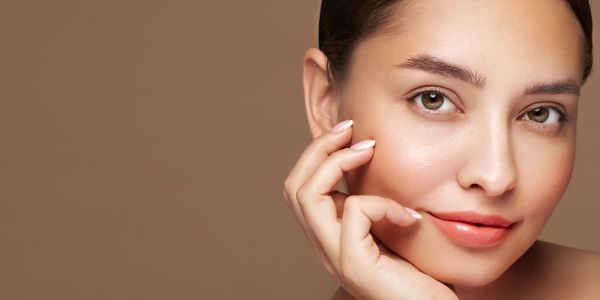 Close-up portrait of a woman with flawless skin and natural makeup.