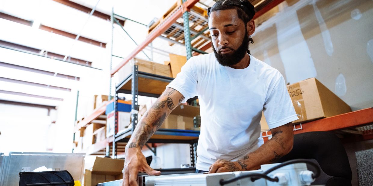 Man working with tools in a warehouse.