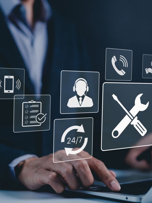 Person using laptop with digital customer service icons.
