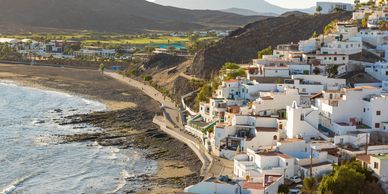 Building sitting cliff side down to sand beaches in the Canary Islands Spain