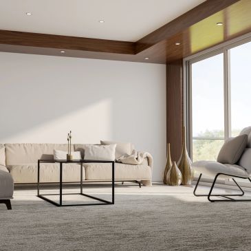 Modern living room with beige sofa and large window.