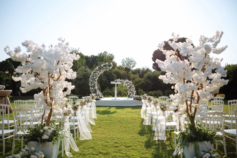 Romantic wedding ceremony. Beautiful setting for outdoors wedding ceremony waiting for bride and groom and guests. Decoration