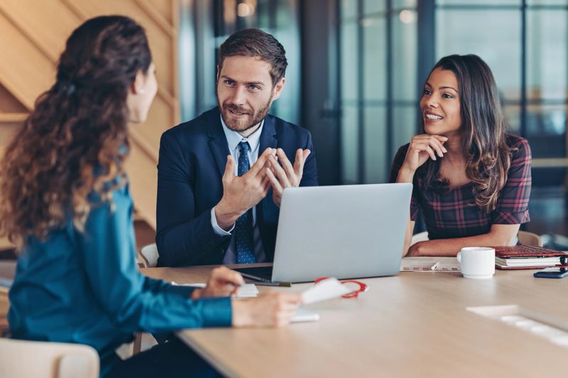 Group of business persons having a meeting in a modern office space