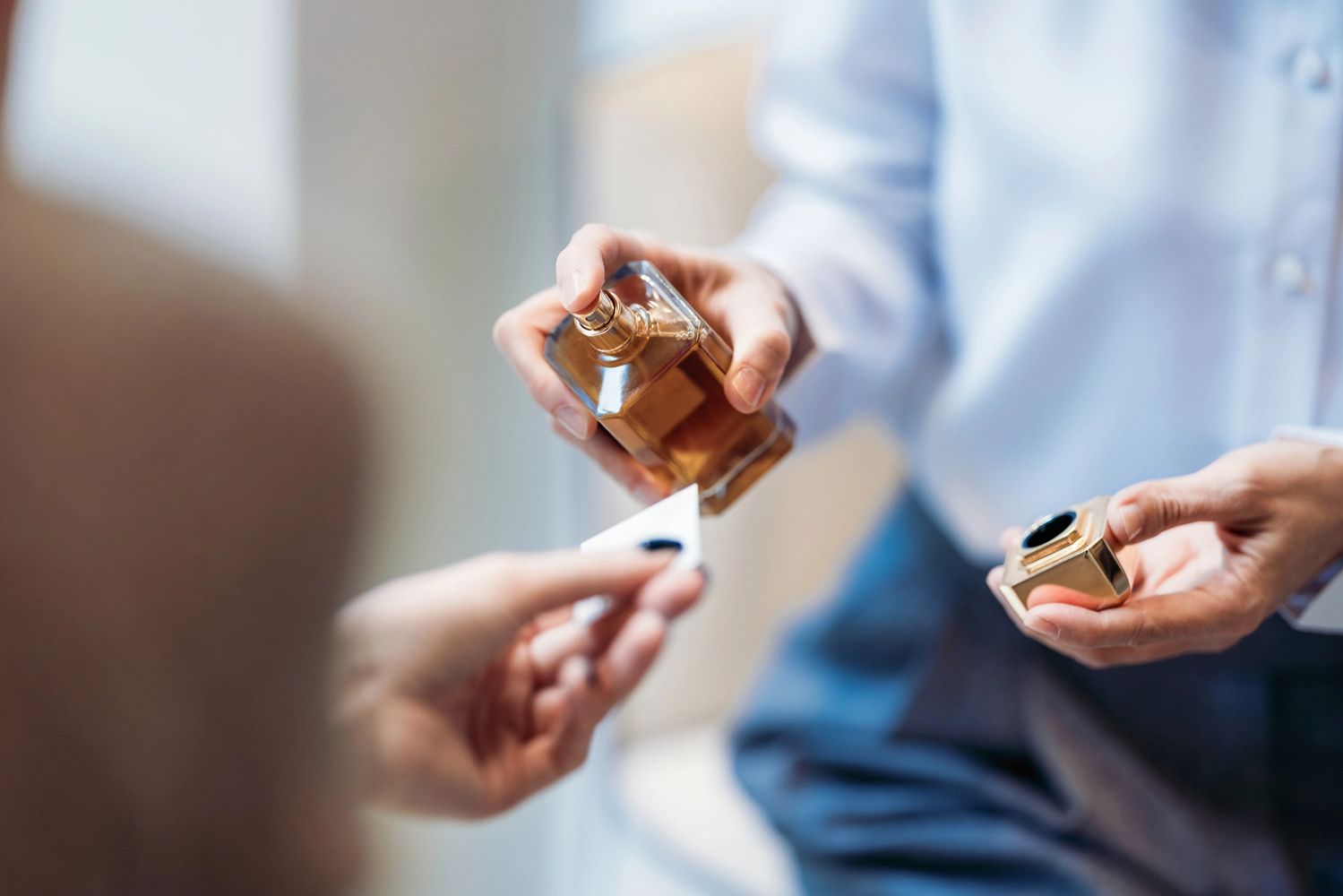Stack of books next to pencils in a holder and a camera.