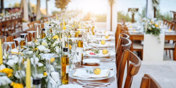 Elegant outdoor table setting with flowers and lemons.