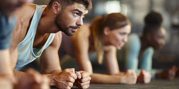 A group of friends doing planks for their workout.