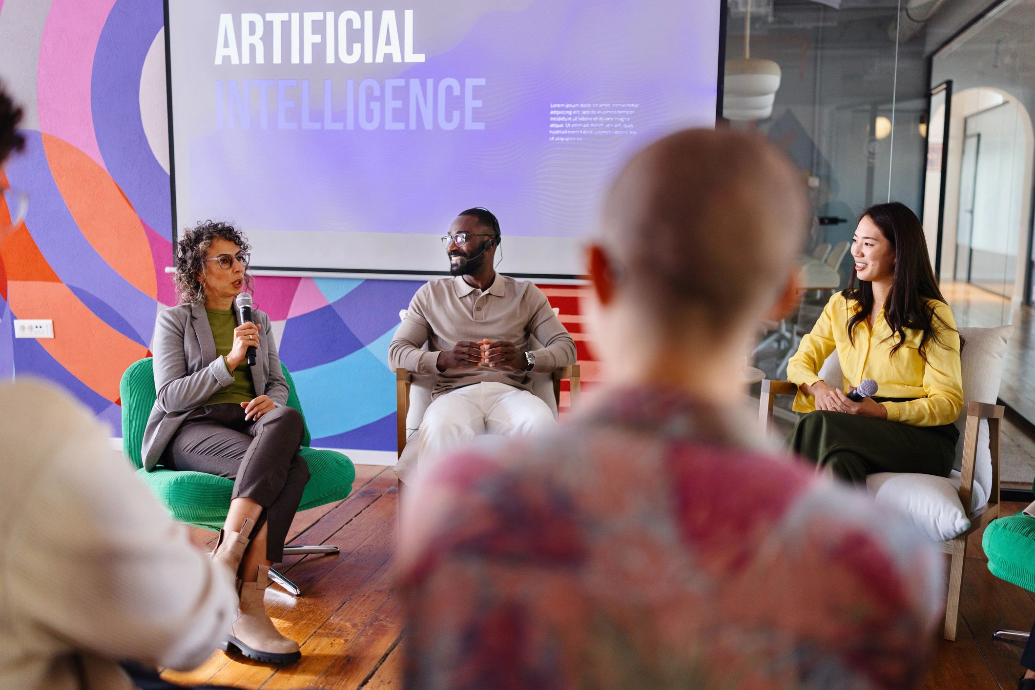 A group of panellists on-stage discussing the future, and AI.