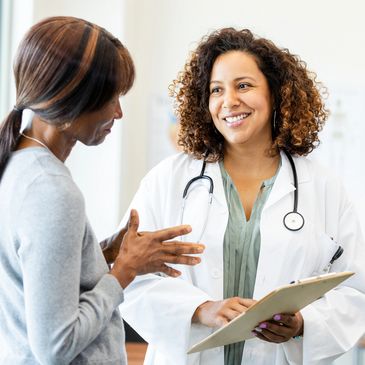 Doctor smiling while talking to a patient.