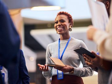 Coaching, leadership, teams, woman greeting others