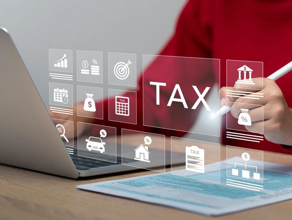 Person using digital tools for tax calculation and financial planning.