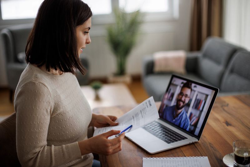 Woman reviewing a resume during a virtual job interview