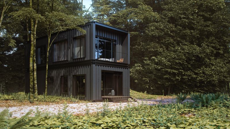 A minimalist black container house in forest, emphasizing sustainable and innovative architecture.