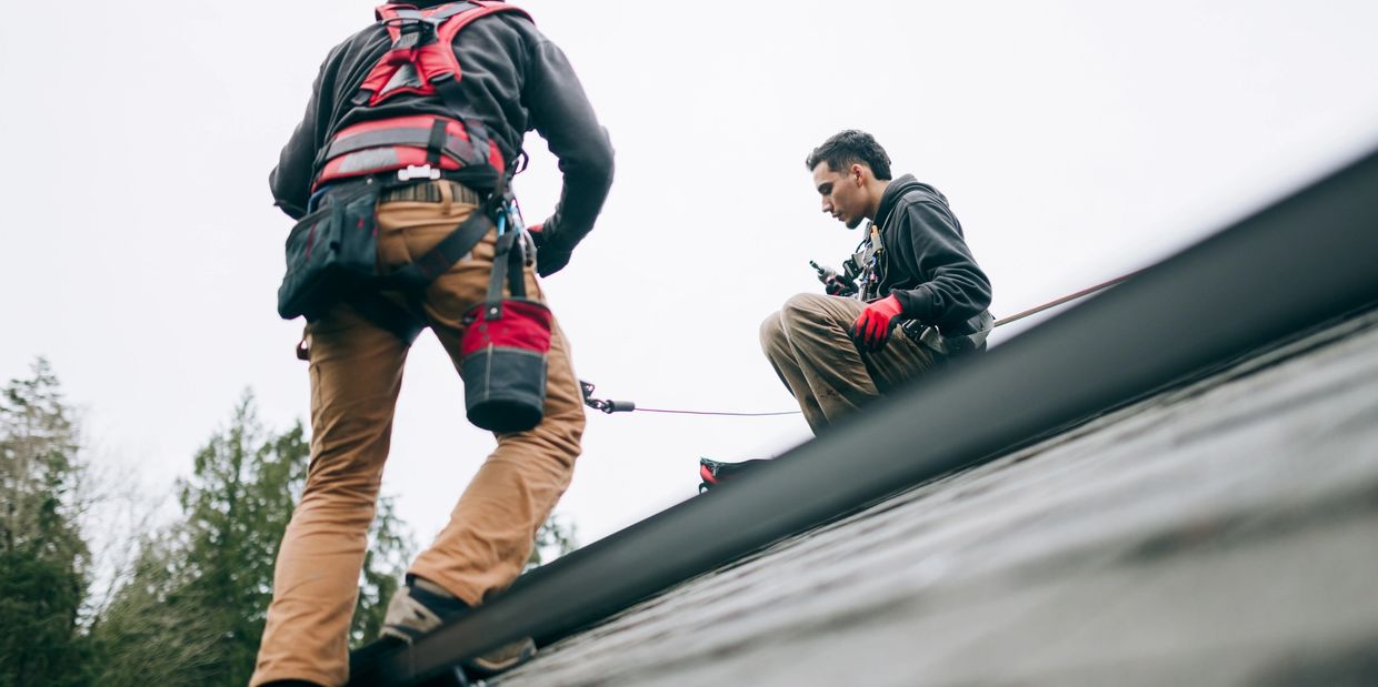 Roofer in Charlotte NC repairing leaking roof
