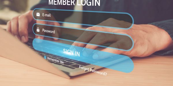 Person typing on laptop with transparent login interface.