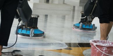 Workers polishing a marble floor.