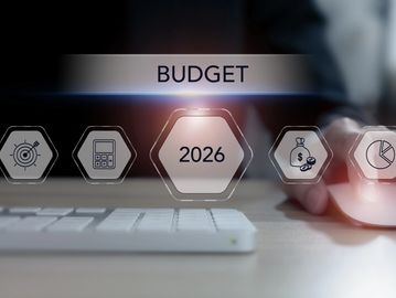 Digital interface showing 2026 budget planning with icons and a hand using a mouse.
