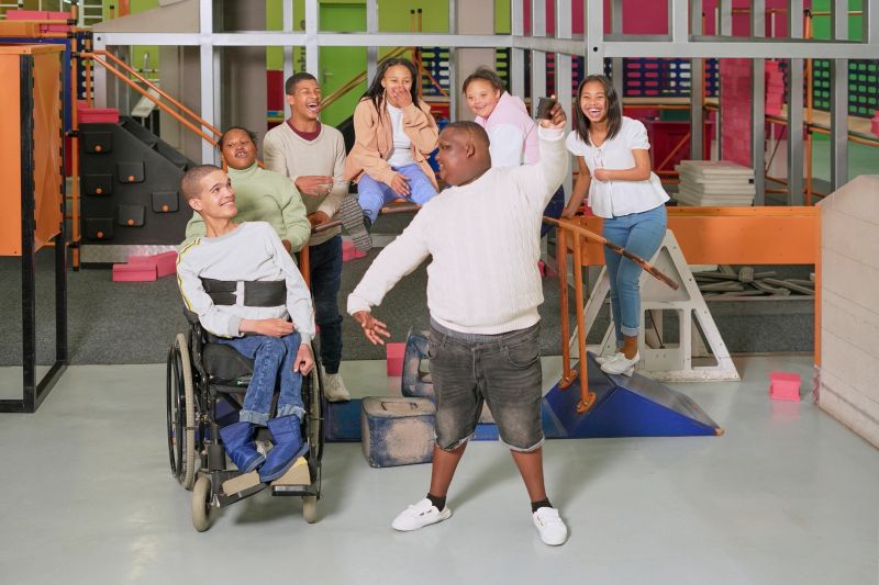 Diverse group of cheerful teenagers in science center