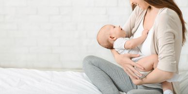 Mother breastfeeding her baby with love.