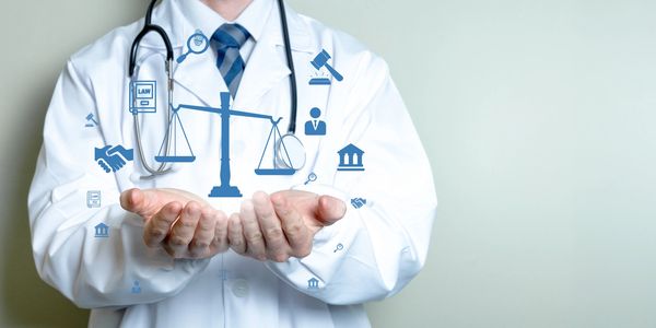 Doctor holding virtual legal justice icons.