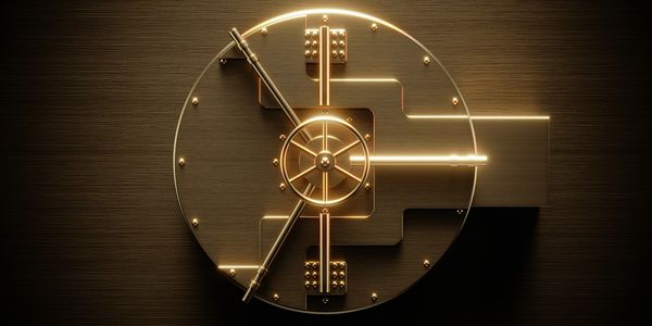 Top view of a golden vault door glowing with light.