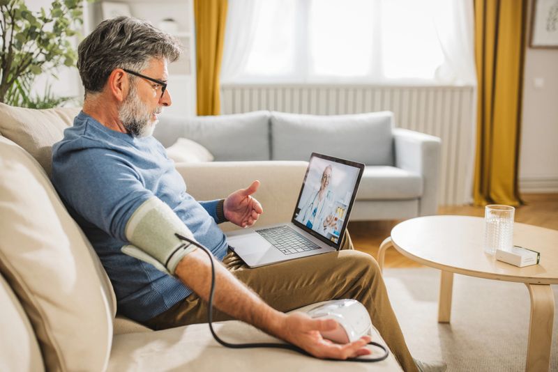 Mature man talking on video call with his doctor and taking his advice's about his symptoms.