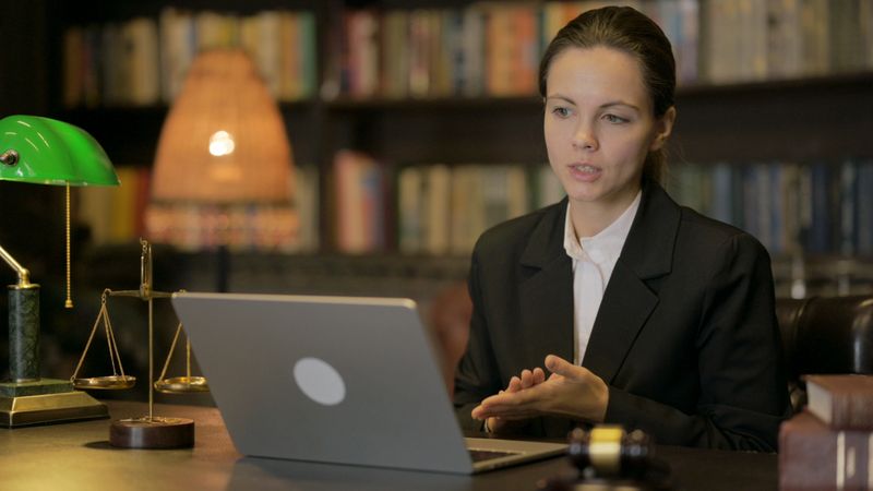 Young Female Lawyer Doing Video Chat on Laptop