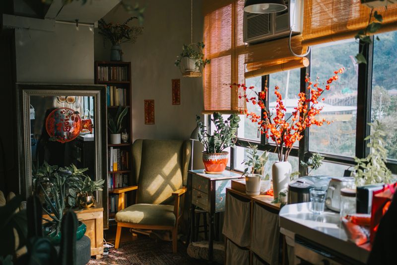 Chinese New Year Home Decoration corner of living room with armchair with window light beside bookshelf and houseplant in Hong Kong