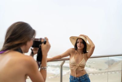 Woman posing for a photo on a balcony.