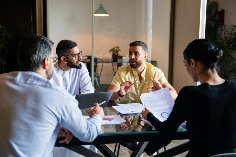 Business professionals brainstorming together in team meeting, ideas, collaboration, teamwork