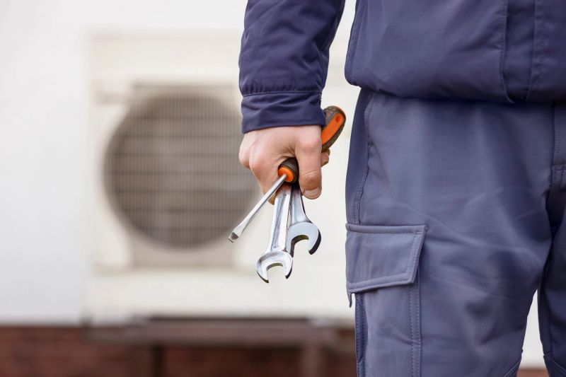Heat Pump Install Service. Worker Hand with Tools Installing Heat Pump System or Conditioner.
