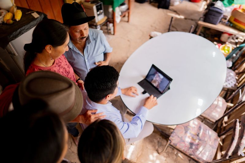 High angle view of a family talking on video call on a farmhouse
