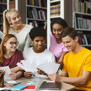 A group of young people looking at documents