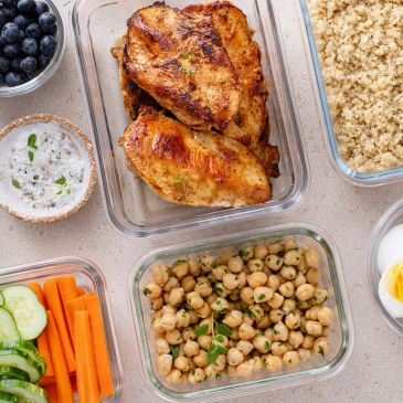 Meal prep with grilled chicken, quinoa, chickpeas, and fresh veggies.