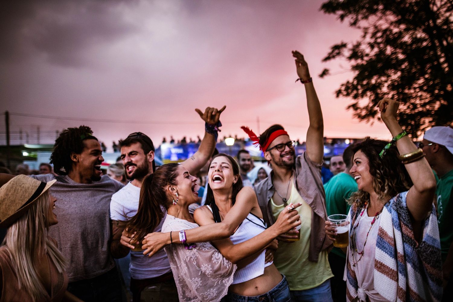 Stack of books next to pencils in a holder and a camera.