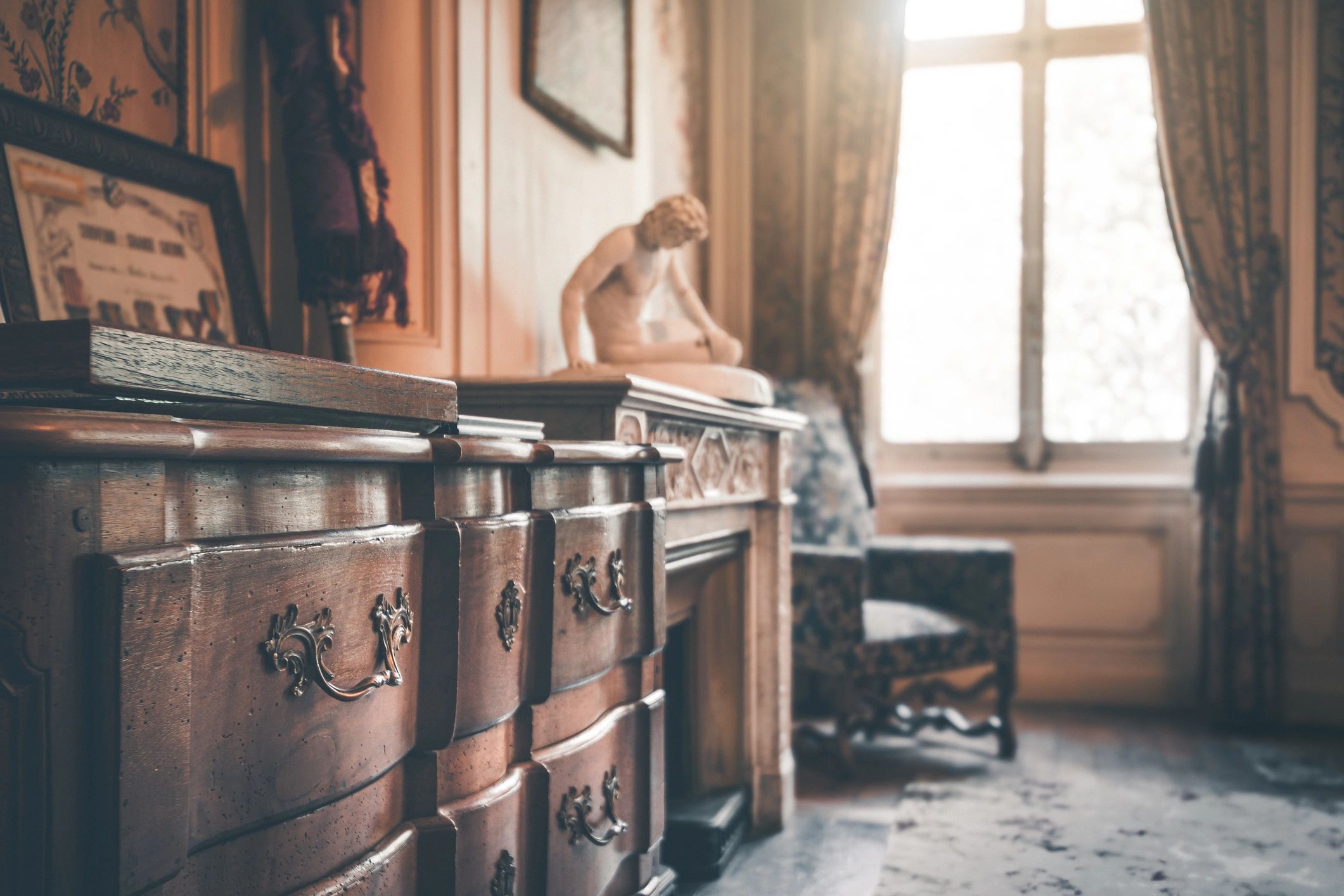 Antique wooden dresser and sculpture in a vintage room.