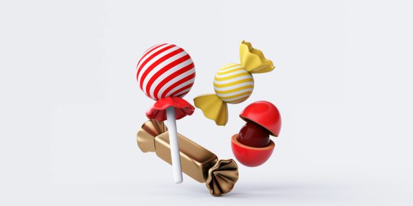 Various colorful candies including a striped lollipop and wrapped sweets on a white background.