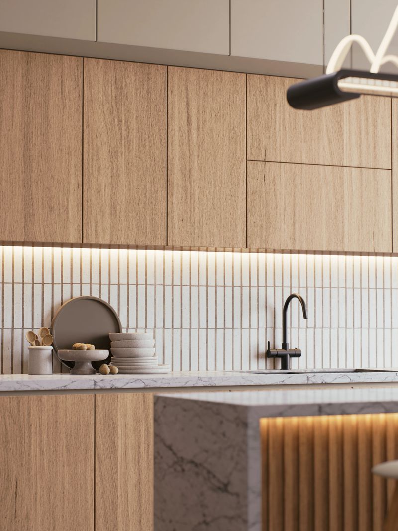 A modern kitchen featuring wooden cabinetry, a marble countertop, a minimalist design, and sleek fixtures, illuminated by soft lighting. 3d rendering.