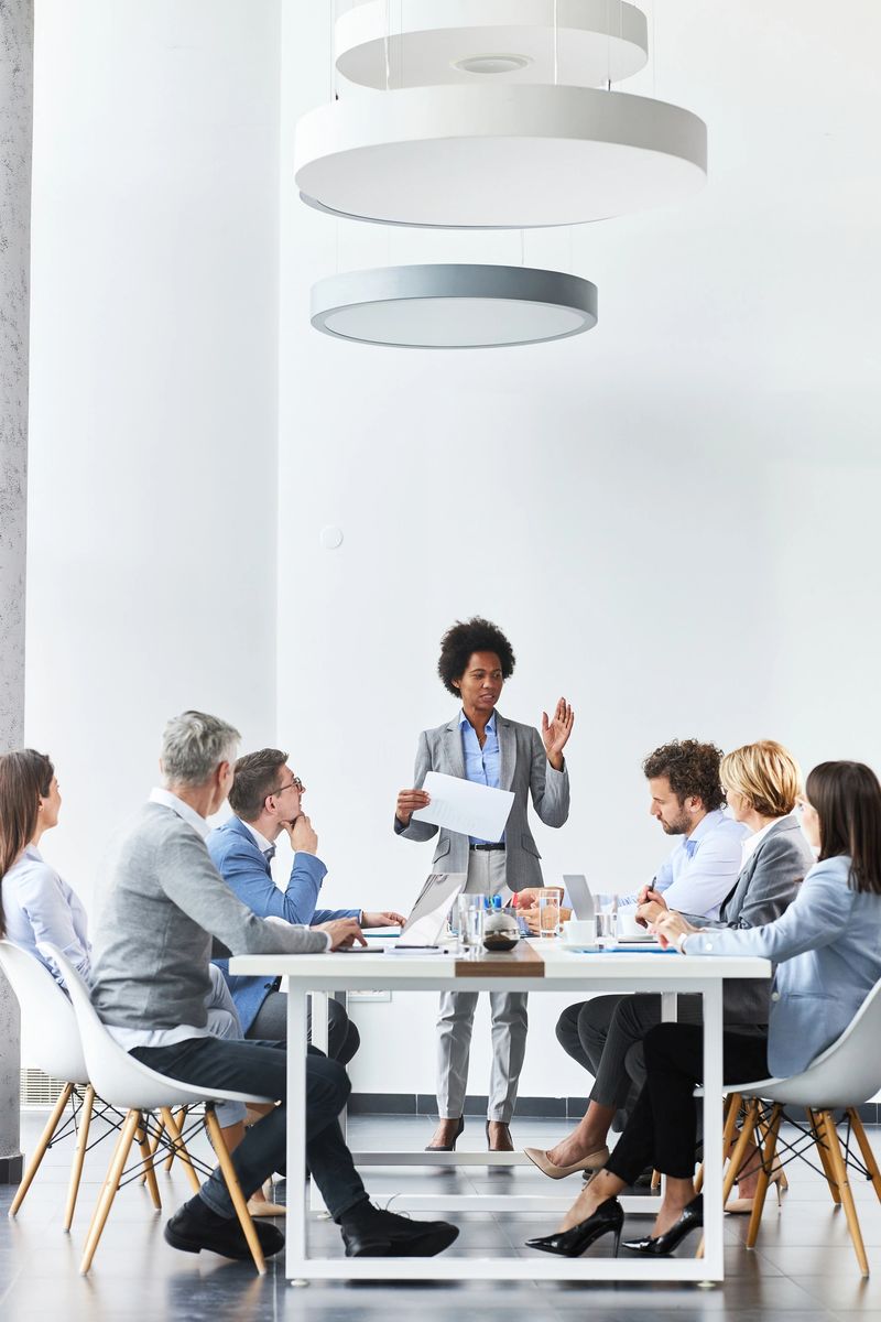 African American businesswoman leading a business meeting where she talks about reports with her colleagues in the office. Copy space.